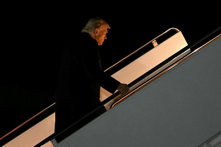 Photo for story: US President Donald Trump boards Air Force One at Joint Base Andrews, Maryland, as he departs for a trip to Asia on October 24, 2025.