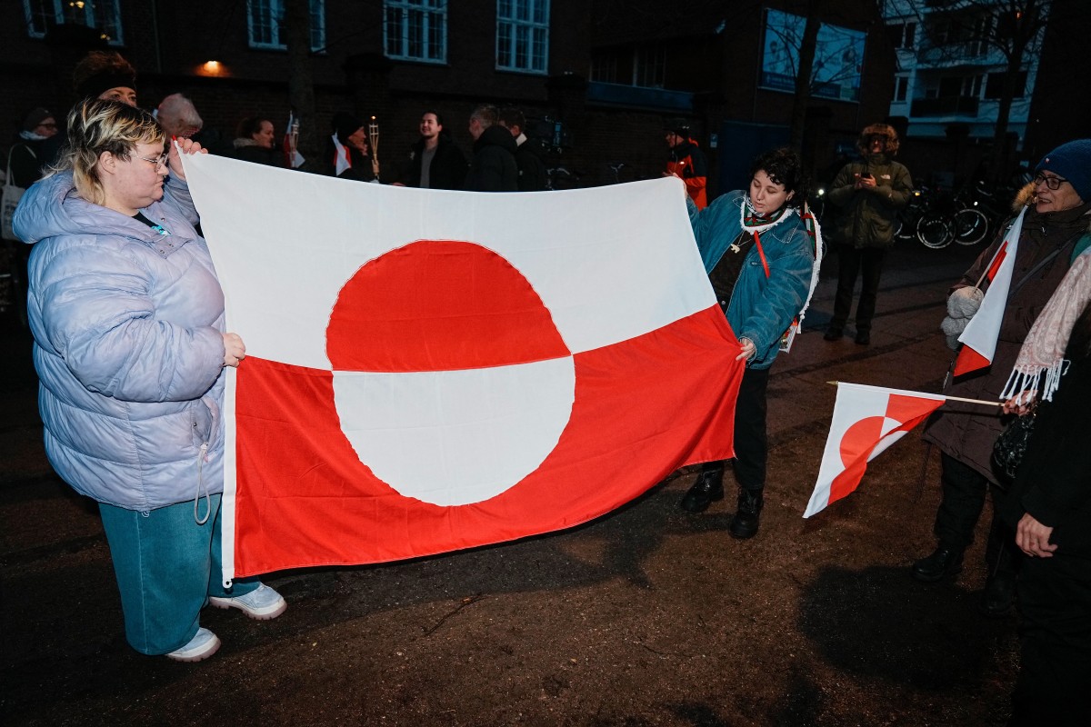 FILE PHOTO: Protestors with Greenlandic flags attend a demonstration under the motto "Greenland is for Greenlanders" in front of the US embassy in Copenhagen on January 14, 2026. Denmark will beef up its military presence in Greenland "from today", the defence ministry said, just before high-stakes talks were to start in Washington over US President Donald Trump's threats to take over the Arctic island. (Photo by Thomas Traasdahl / Ritzau Scanpix / AFP)